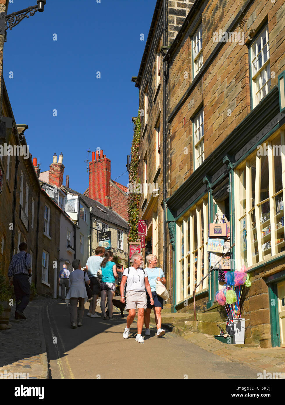 People walking up and down King Street in Robin Hoods Bay, the busiest smuggling community on the Yorkshire coast during the 18t Stock Photo