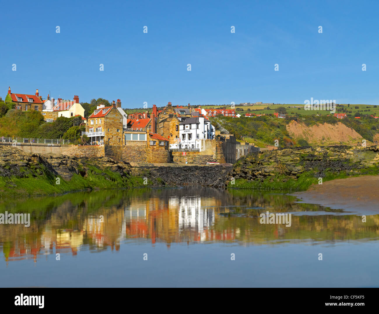 Reflections in a pool of water on the beach at Robin Hoods Bay, the busiest smuggling community on the Yorkshire coast during th Stock Photo
