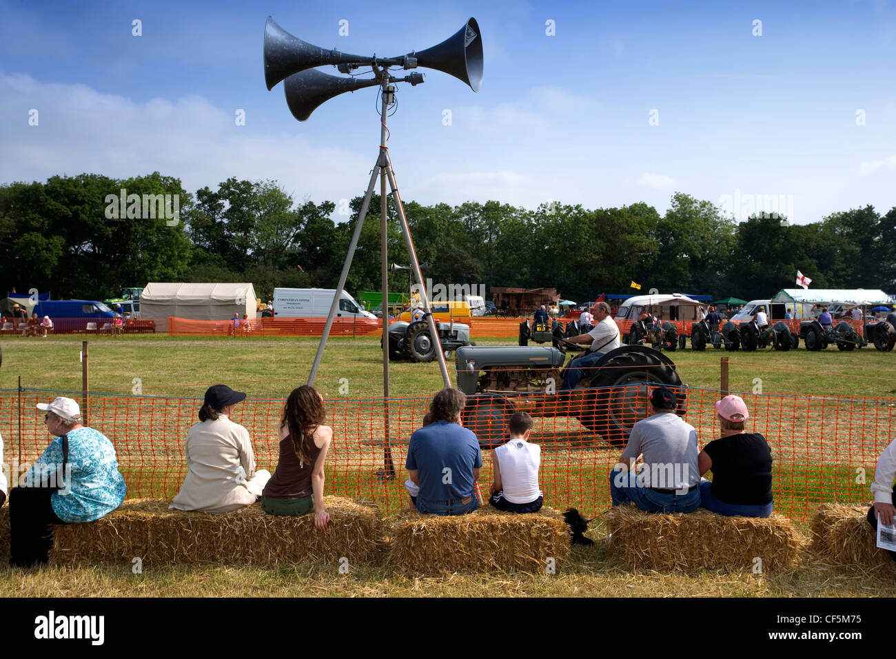 Watching the tractors at the Whitwell Steam and Country Fair. Steam tractors were built as small road locomotives and were opera Stock Photo
