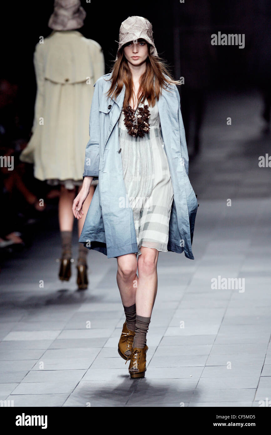 Burberry Prorsum Milan Ready to Wear Spring Summer Muted Tones Bucket hat,  light blue trenchcoat, smock dress, socks and laceup Stock Photo - Alamy