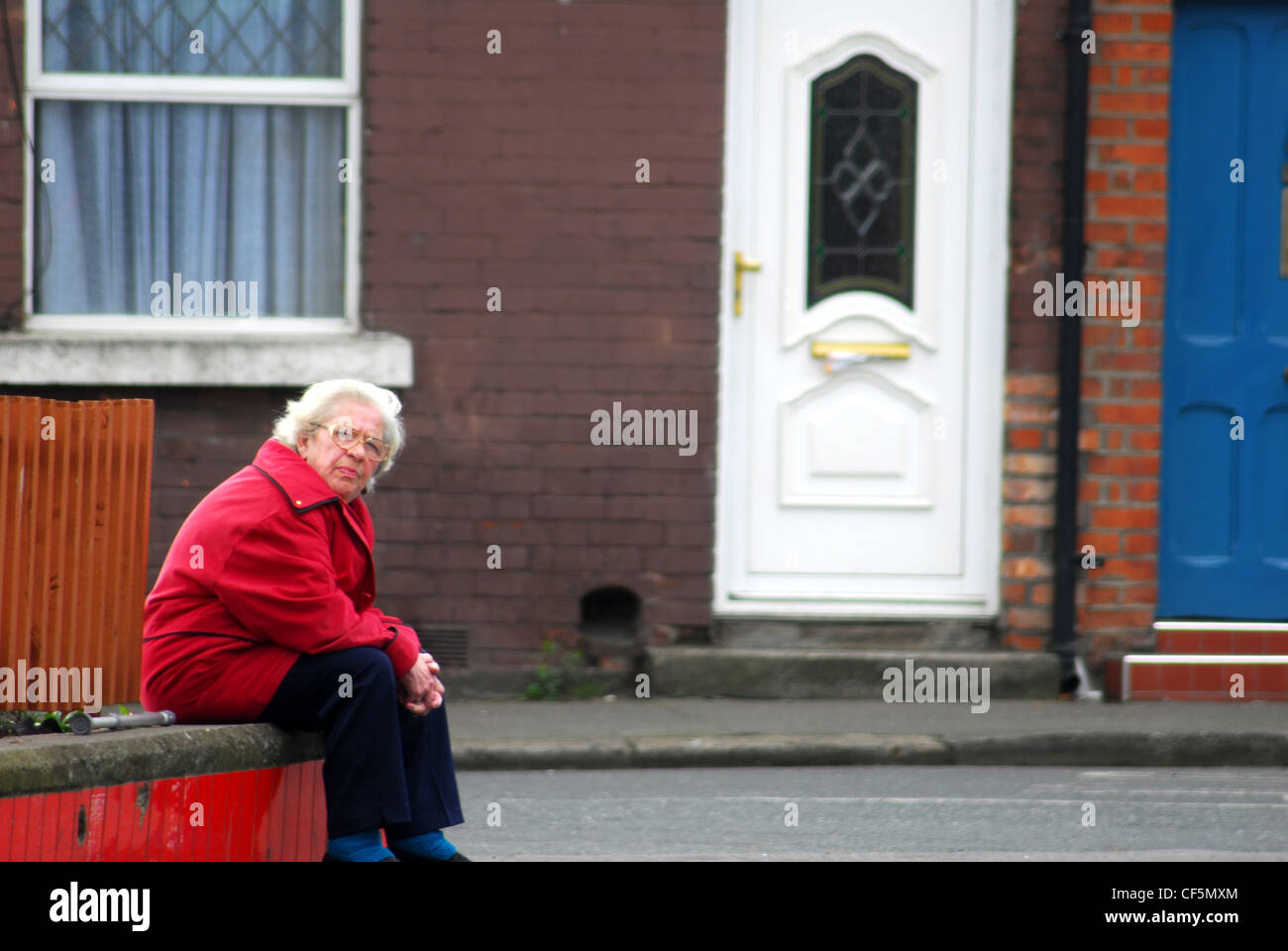 A woman sitting on wall in The Liberties. Stock Photo