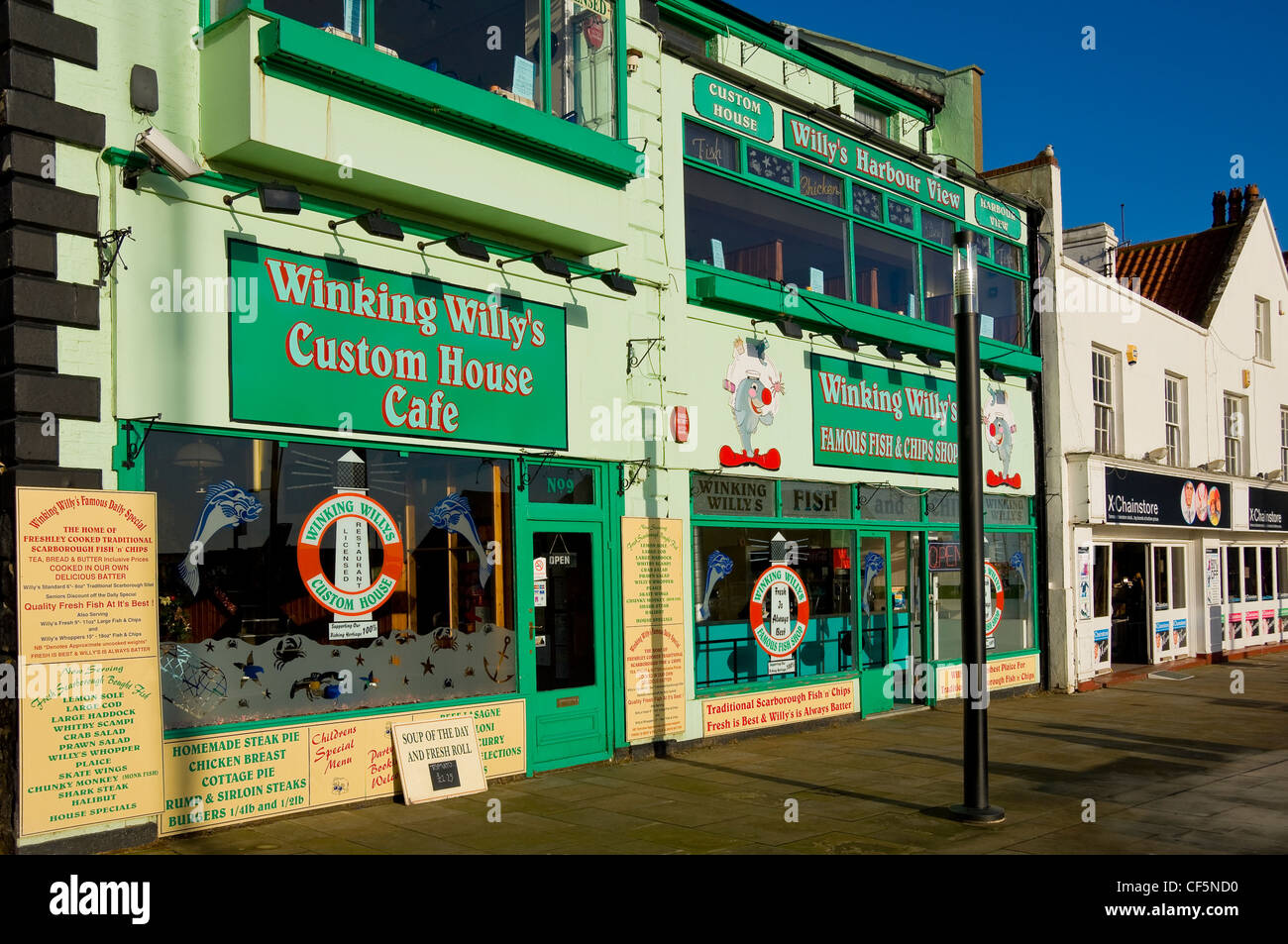 'Winking Willy's Custom House Cafe' and 'Famous Fish and Chip Shop' restaurants on the seafront at Scarborough. Stock Photo