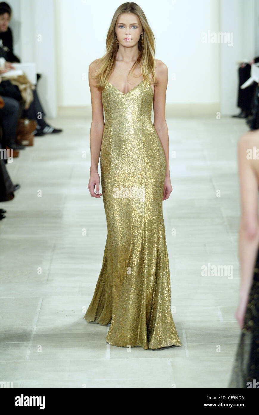Ralph Lauren New York Ready to Wear Autumn Winter Blonde female model Valentina Zelyaeva wearing a gold sparkle maxi length Stock Photo