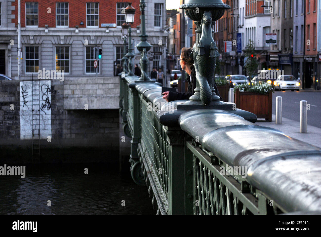 A woman on a bridge over the River Liffey in Dublin Stock Photo - Alamy