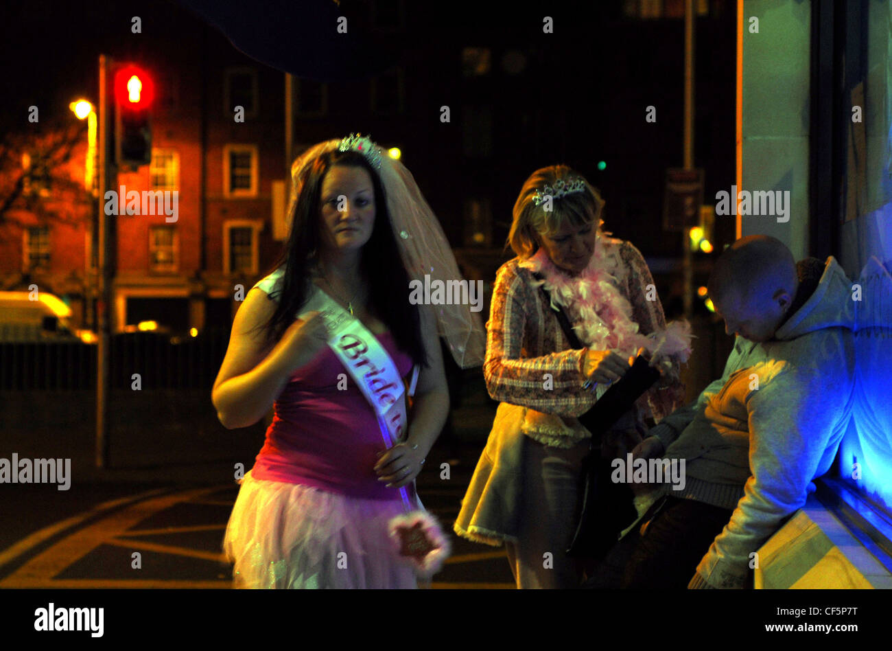 Girls on a hen night looking after drunk friend in the Temple Bar area of Dublin. Stock Photo