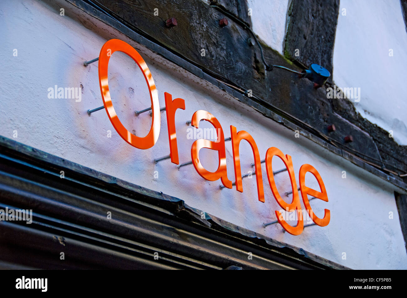 Orange mobile phone provider and telecoms company sign outside a shop. Stock Photo