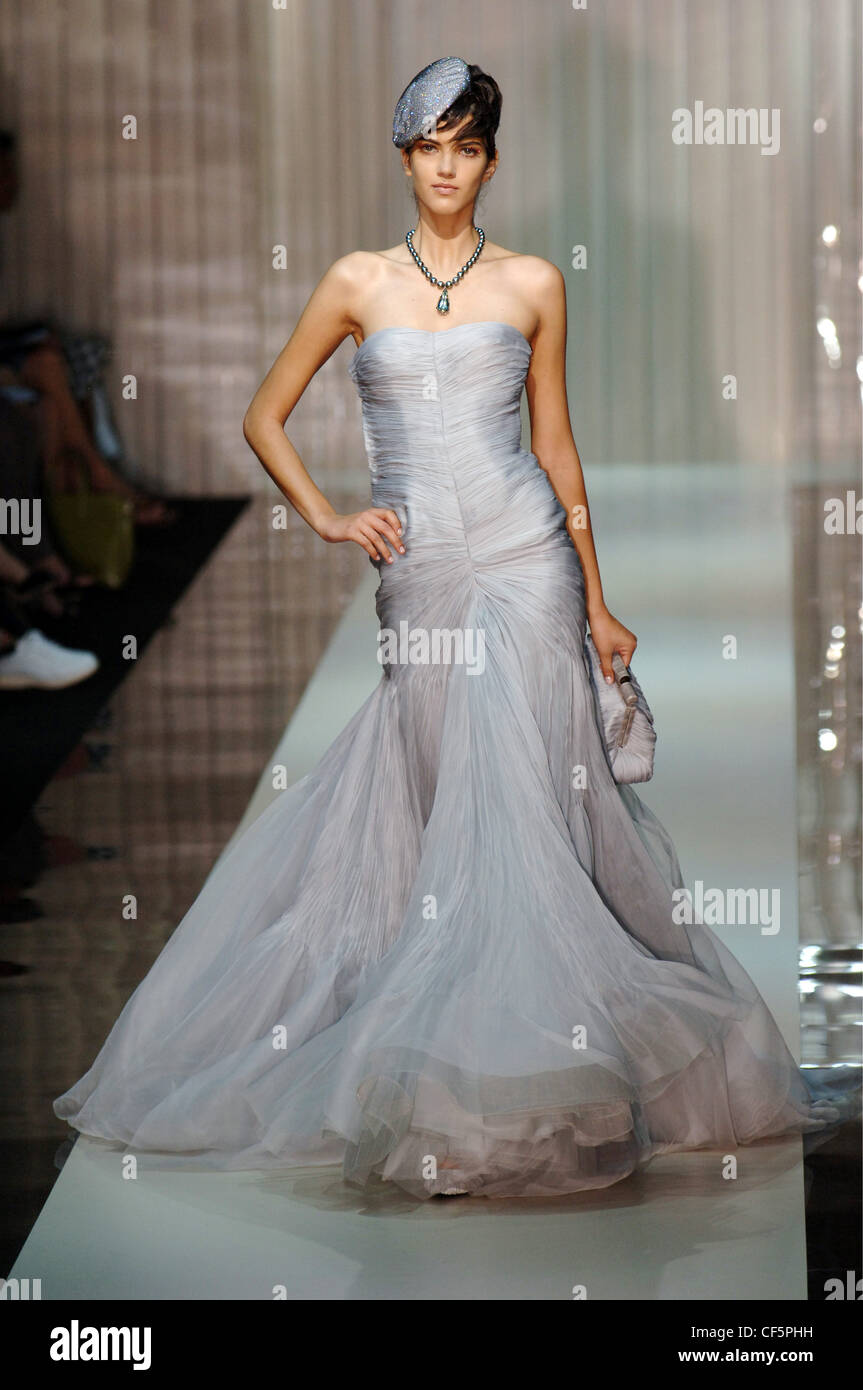 Giorogio Armani Paris Haute Couture Autumn Winter Brunette female model  wearing a grey maxi length strapless chiffon dress full Stock Photo - Alamy