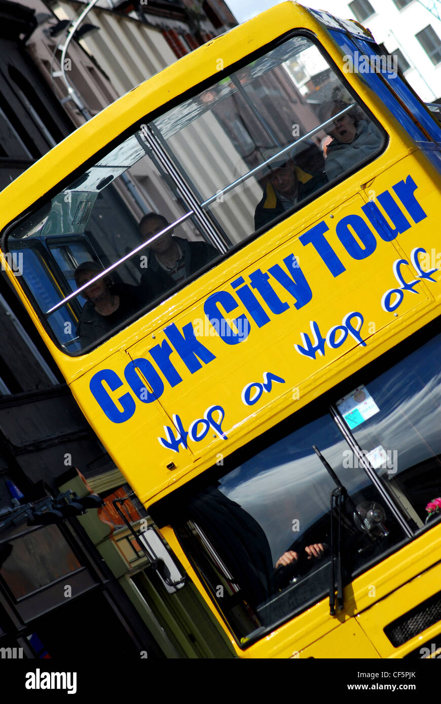 The front of a yellow city tour bus in central Cork Stock Photo Alamy