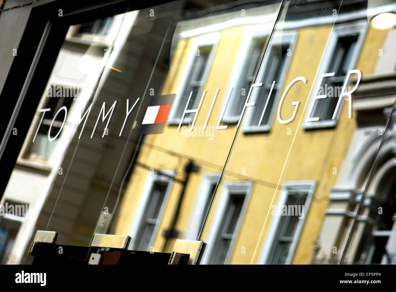 Reflections in the window of a Tommy Hilfiger shop in Cork Stock Photo -  Alamy