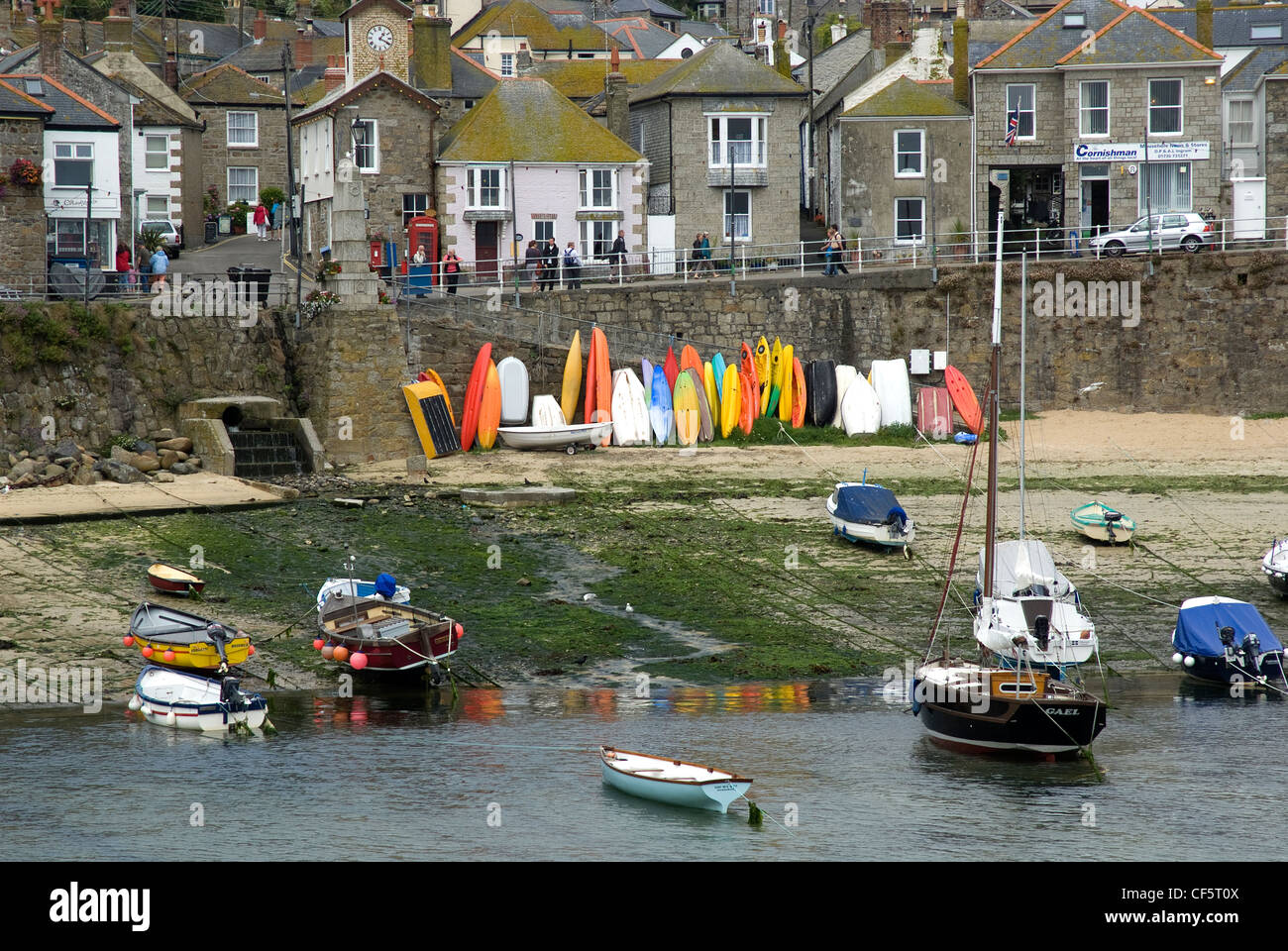 Small boats in Mousehole Quay at low tide. Stock Photo