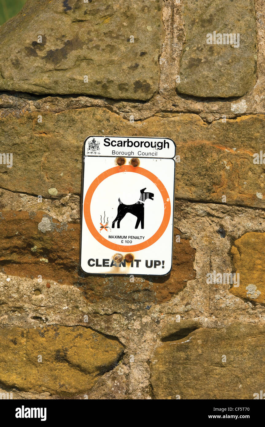 Dog fouling penalty sign attached to a stone wall. Stock Photo
