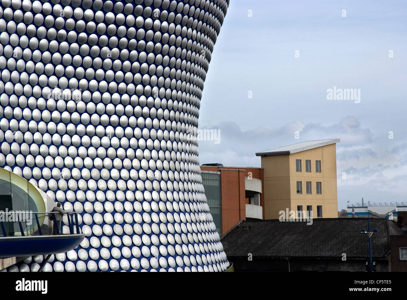 A man standing on a viewing platform outside the futuristic Selfridges store in Birmingham's Bullring shopping complex. Stock Photo