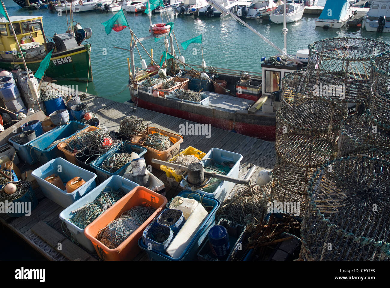 Fishing boats and tackle by a jetty in Brighton Marina. Stock Photo