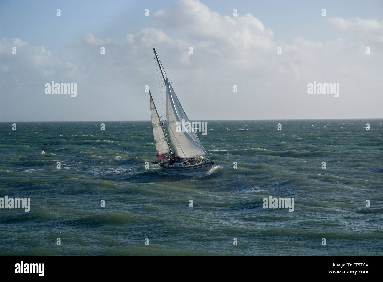 A yacht sailing off Brighton Marina on the English Channel. Stock Photo