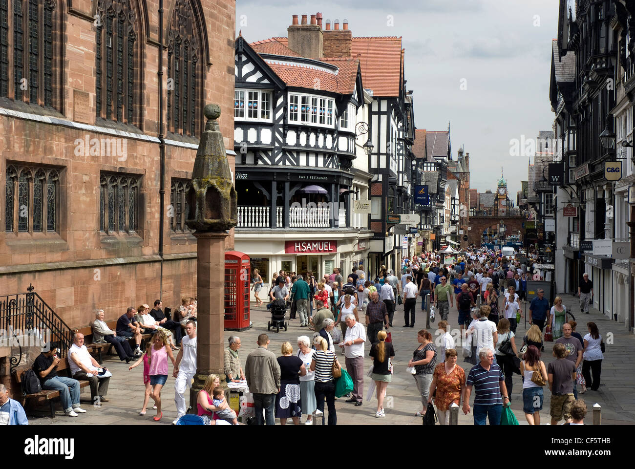 View along a busy Eastgate Street towards the Eastgate clock in Chester. Stock Photo