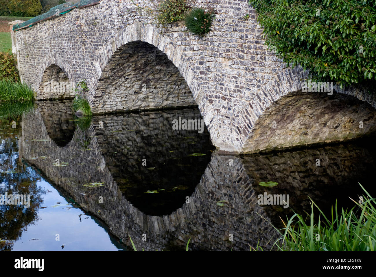 The bridge over the River Wey connecting Waverley Abbey and Waverley Abbey House. Stock Photo