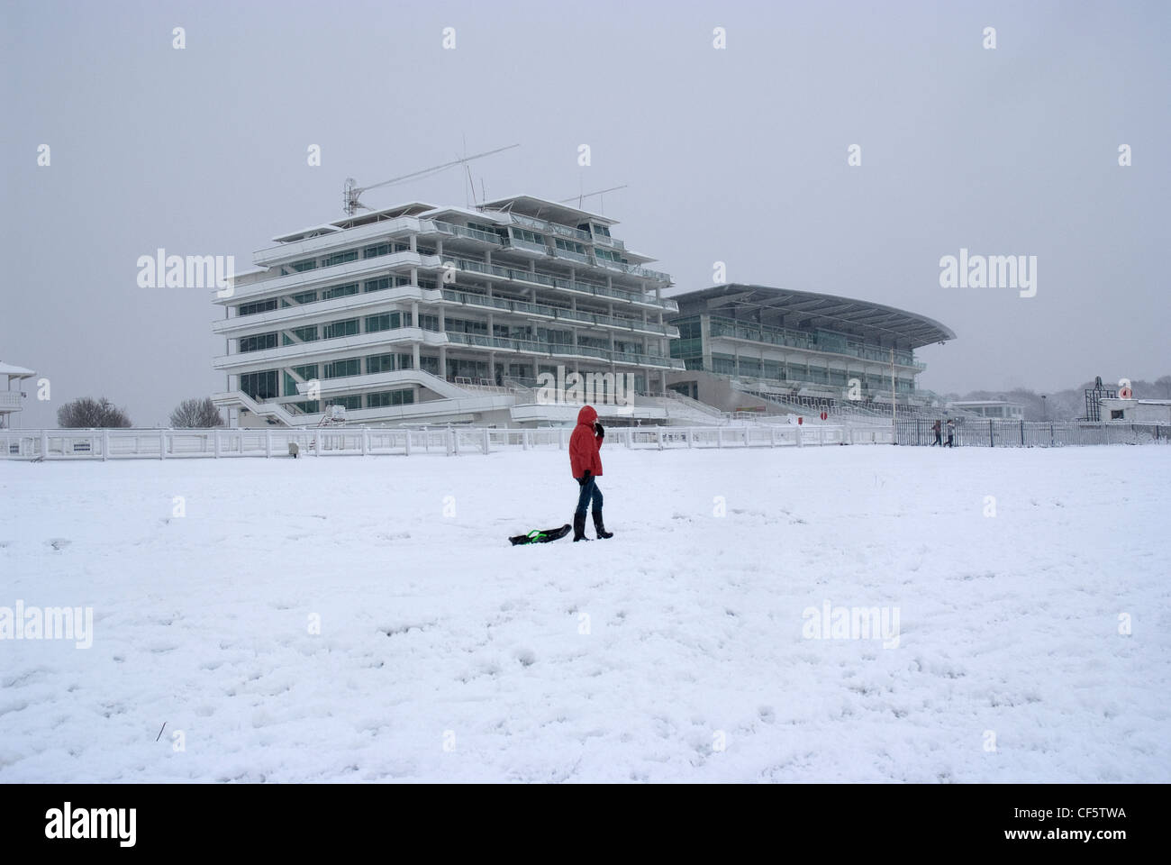 People with sledges looking for a good slope at Epsom racecourse. Stock Photo