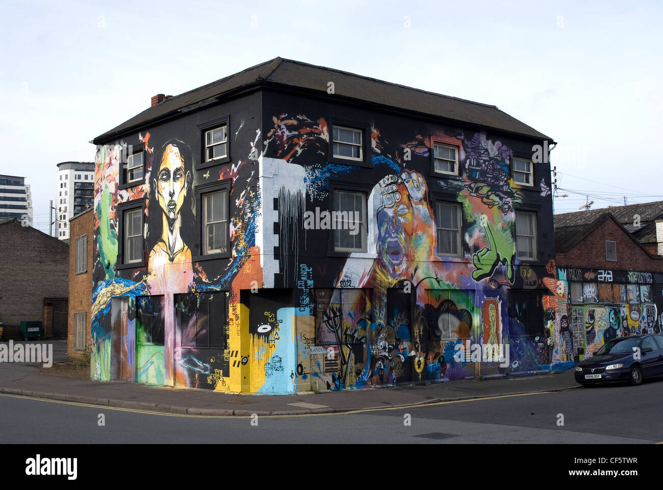 A building on a street corner in Birmingham covered in graffiti. Stock Photo