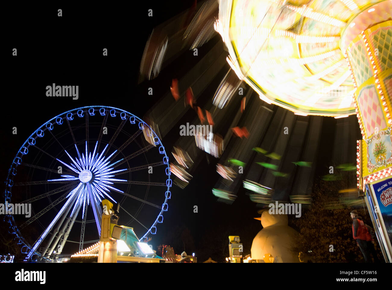 Carousel and big wheel at the Winter Wonderland in Hyde Park. Stock Photo