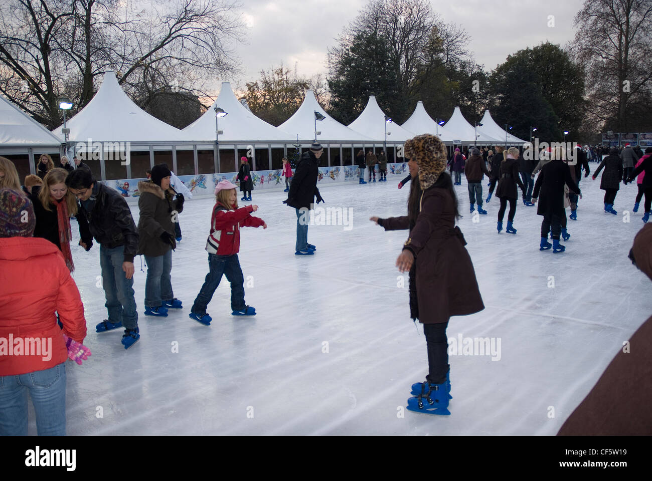 Family fun on the ice rink at the Winter Wonderland in Hyde Park. Stock Photo