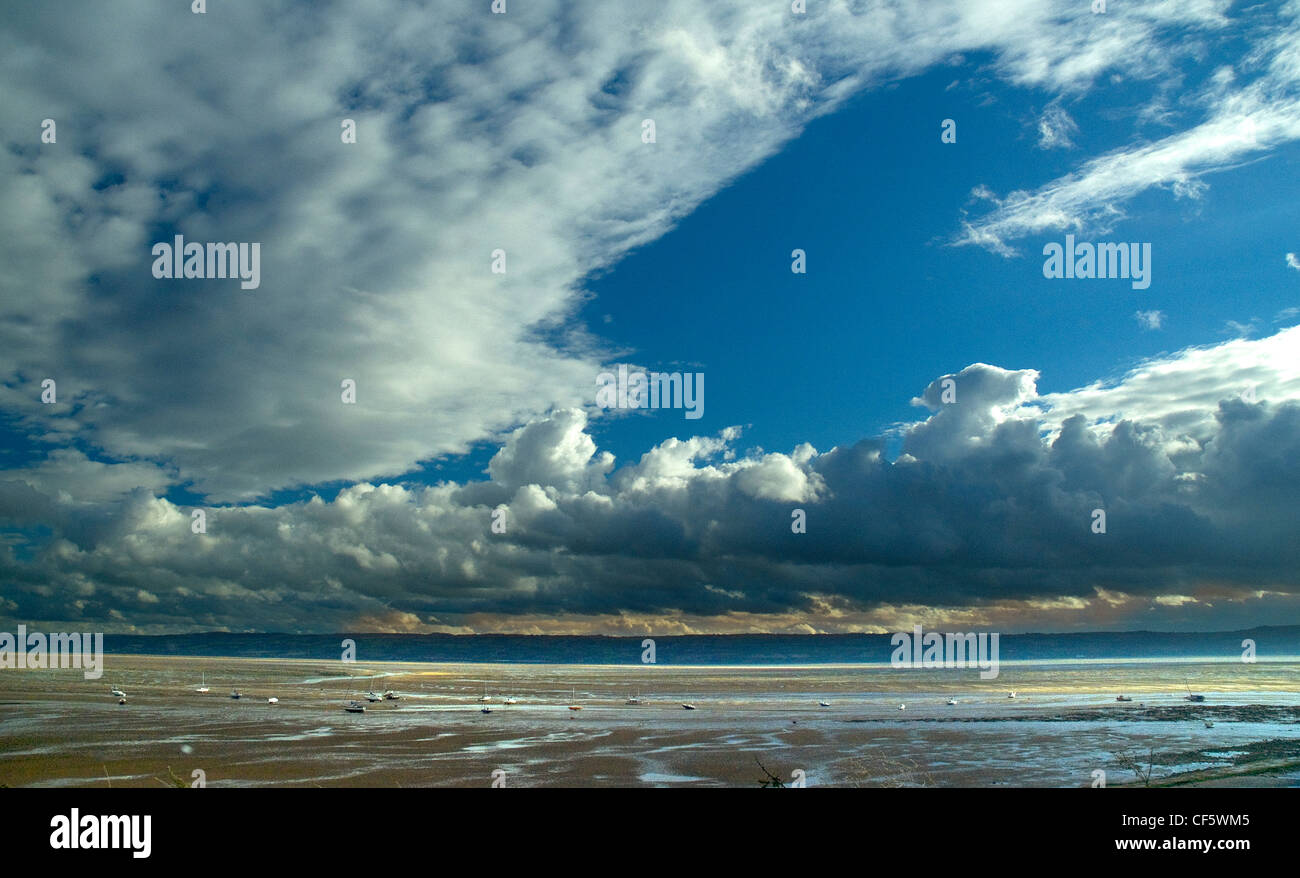 Small boats on the mudflats of the Dee Estuary. Stock Photo