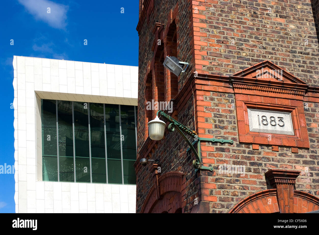 An old wharf building in front of the new Museum of Liverpool on Mann Island. Stock Photo