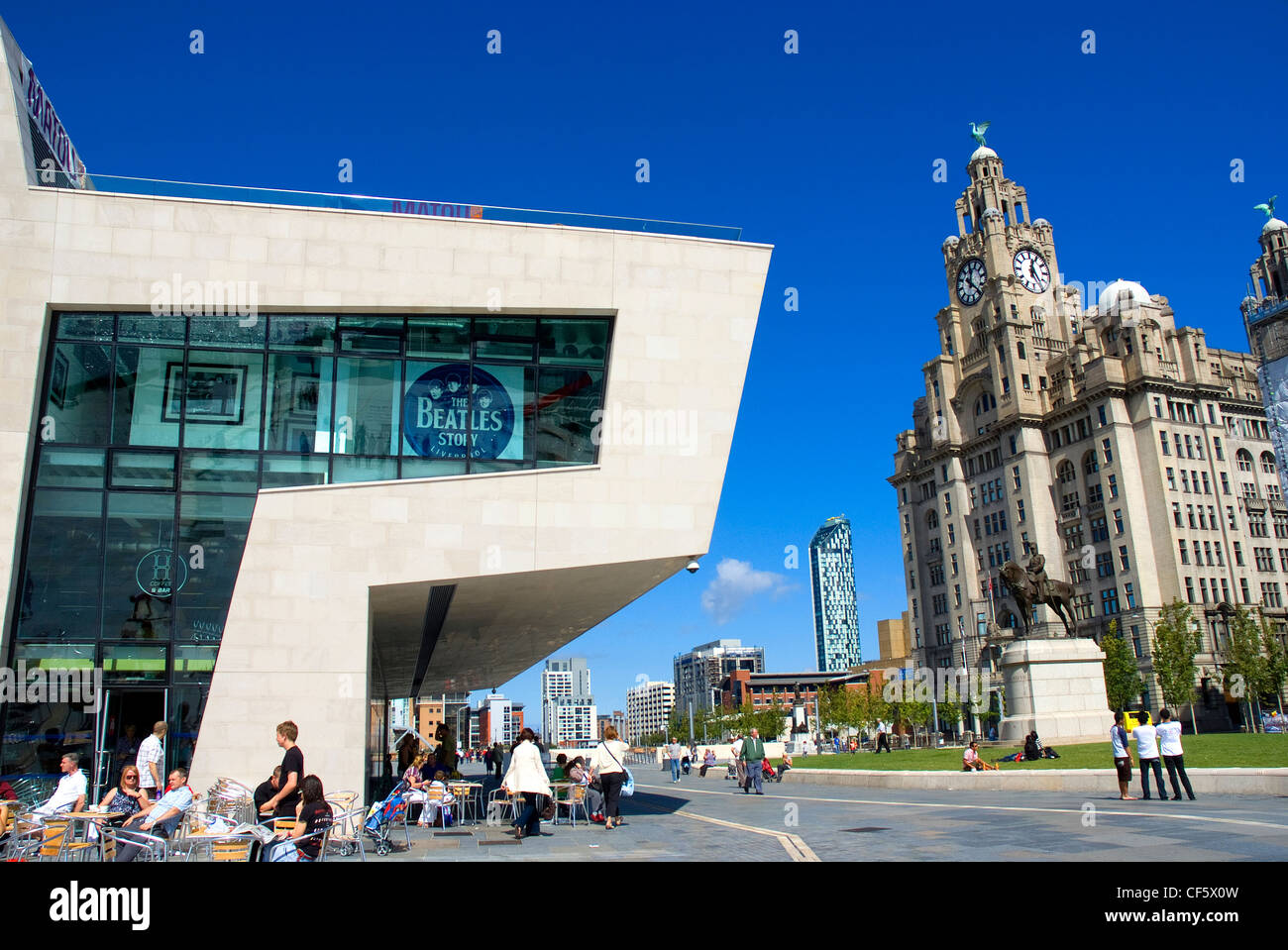 Beatles Story Pier Head in front of The Royal Liver Building, one of Liverpool's Three Graces. Stock Photo