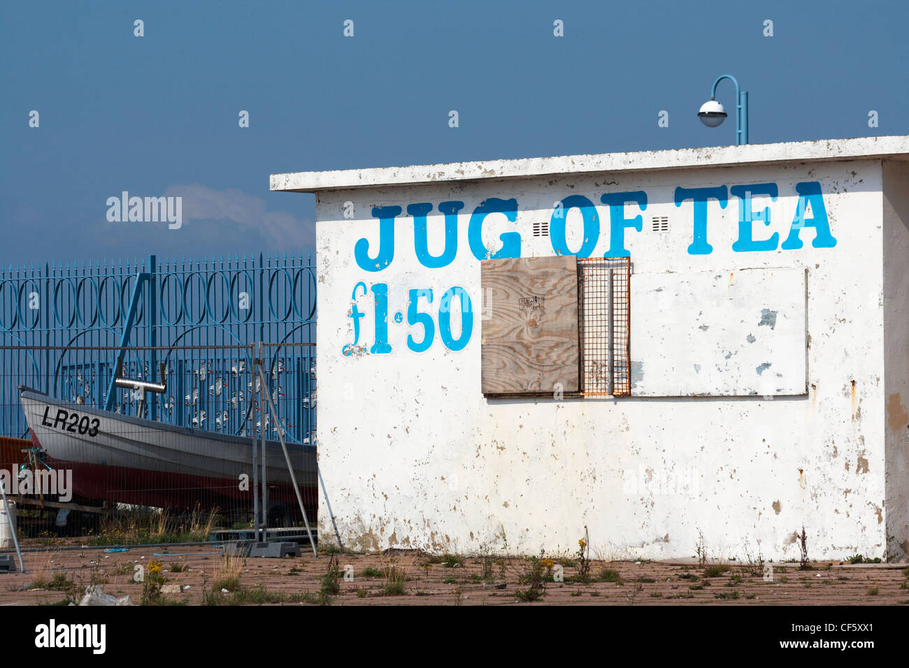 A sign advertising a jug of tea painted on the front of a closed cafe in Morecambe. Stock Photo