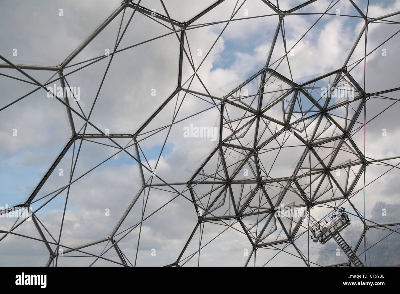 Looking to the sky through the hexagonal cladding panels covering a biome at the Eden Project. The biomes allow for the creation Stock Photo