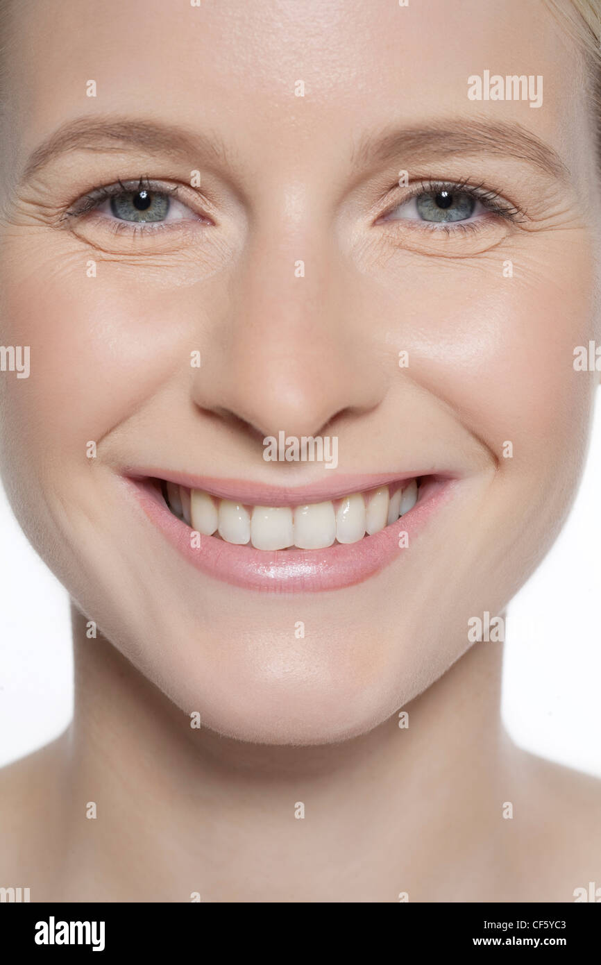 Female wearing subtle make up, smiling, looking at camera Stock Photo