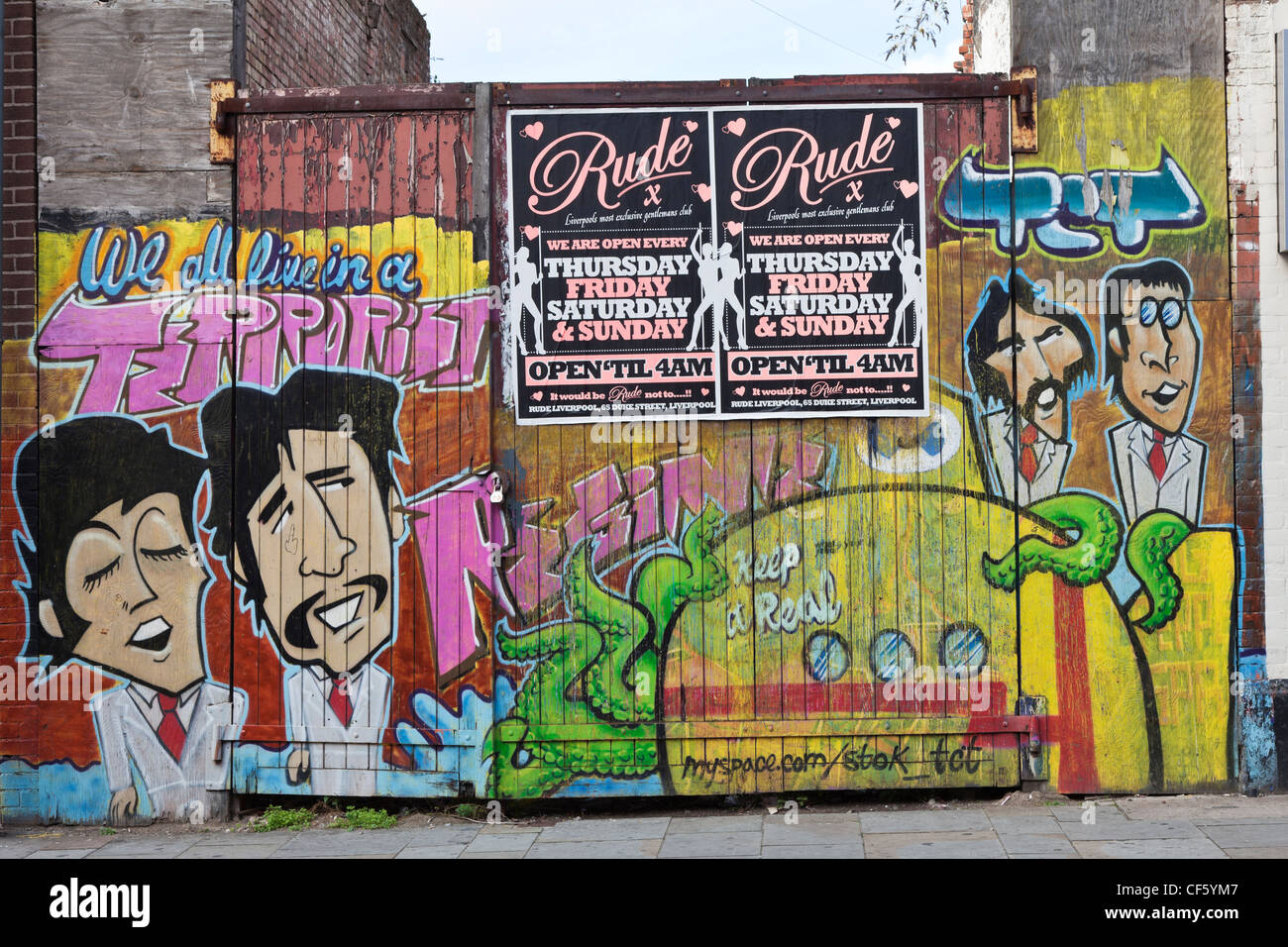 Grafitti sprayed across a gate featuring the Beatles. Stock Photo