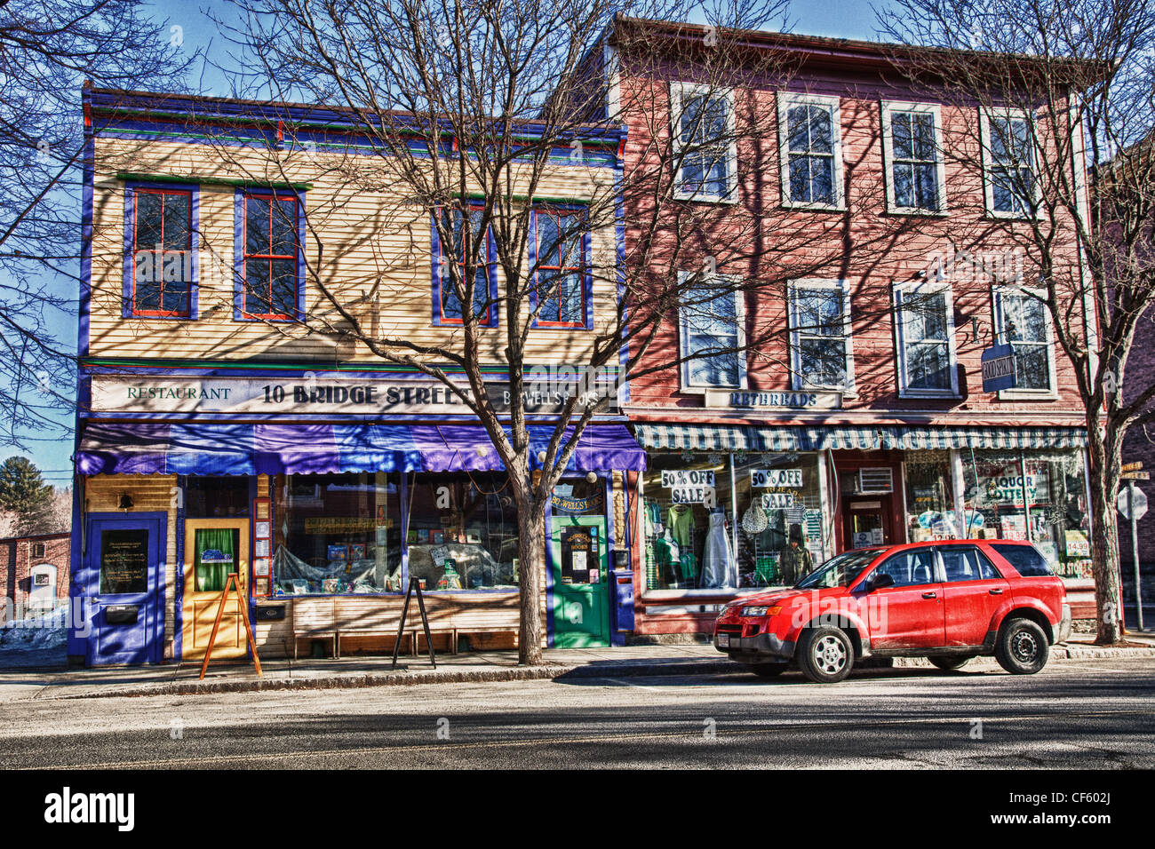Red car in front of shops in downtown Shelburne Falls, MA Stock Photo