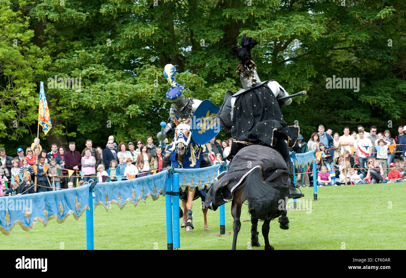 Two knights battle in a jousting tournament at Hedingham Castle. Stock Photo