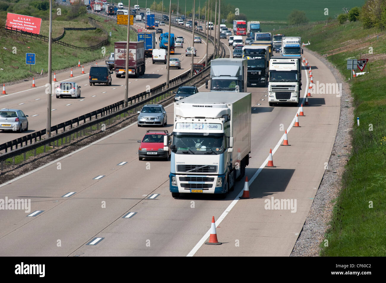 A constant stream of traffic passing through Essex on the M25 London Orbital Motorway. Stock Photo