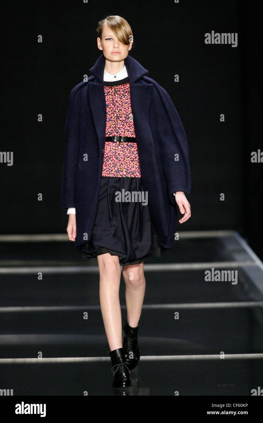 Cacharel Paris Ready to Wear Autumn Winter Blue coat round shoulders,  patterned top black belt, black a line skirt and black Stock Photo - Alamy