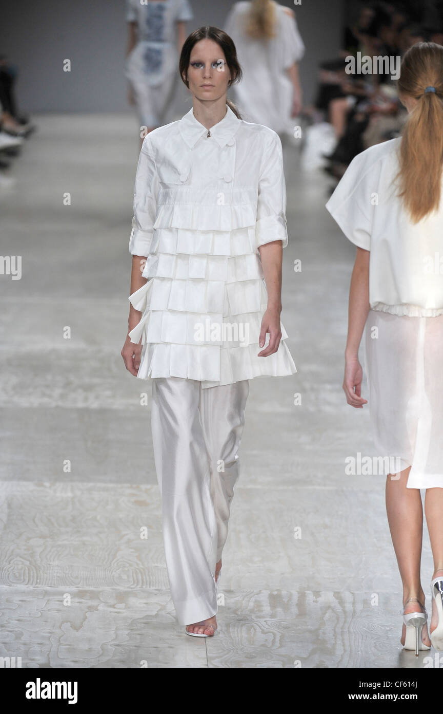 Roberto Cavalli Milan Ready to Wear S S Model Carmen Kass very long blonde  wavy hair wearing white ruffled sleeveless blouse Stock Photo - Alamy