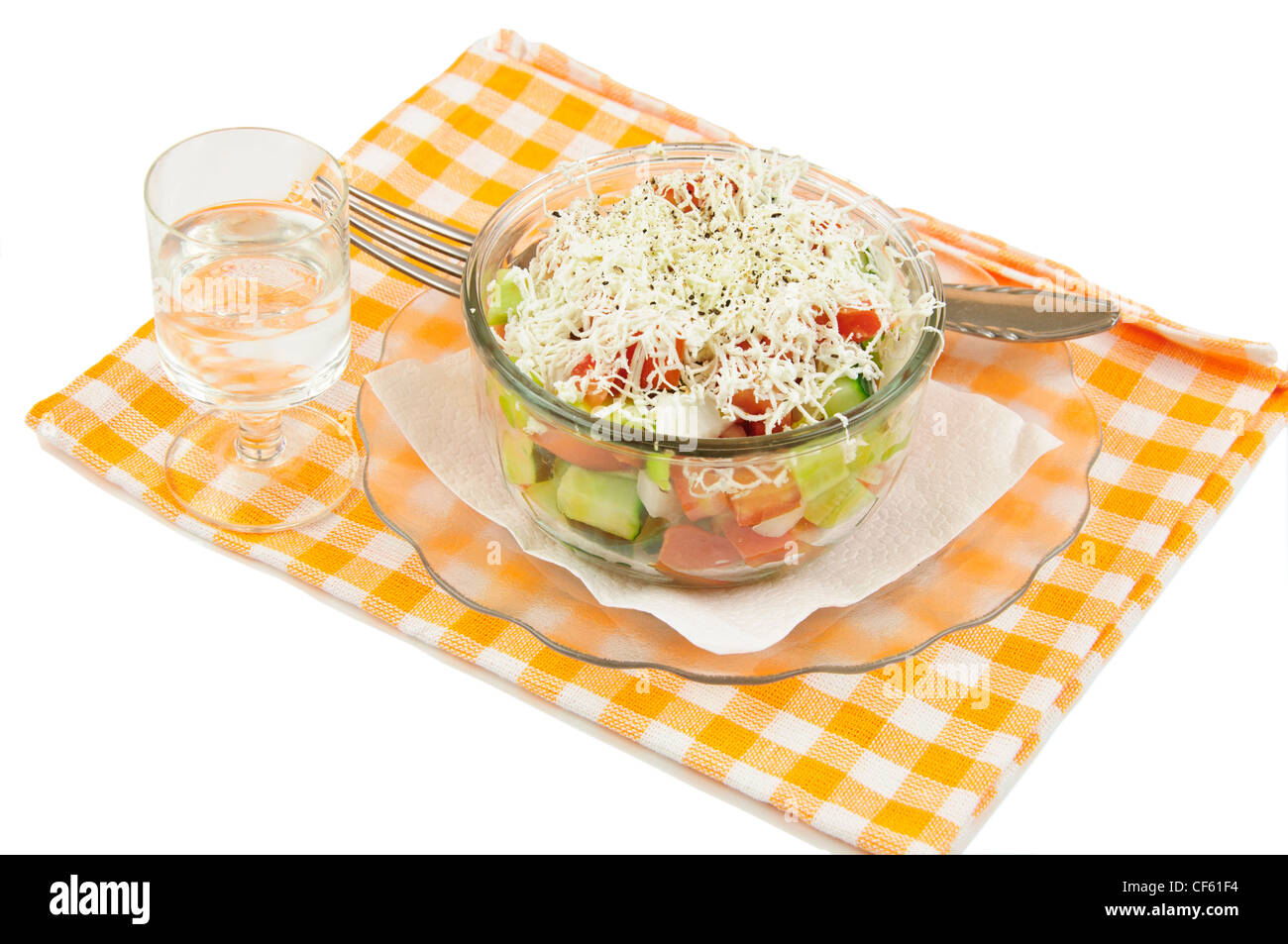 Shopska mixed salad in glass plate,ouzo and napkin on white Stock Photo
