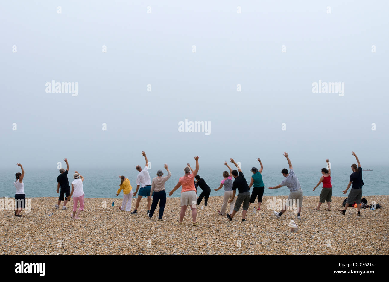 An exercise class takes place on the beach at Eastbourne. Stock Photo