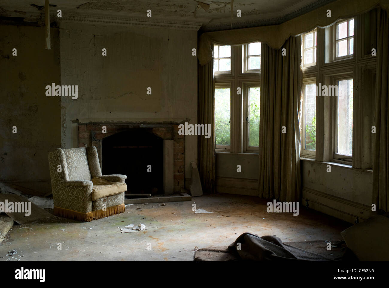 The Interior Of A Deralict Living Room With A Lonely Worn Armchair Stock Photo Alamy