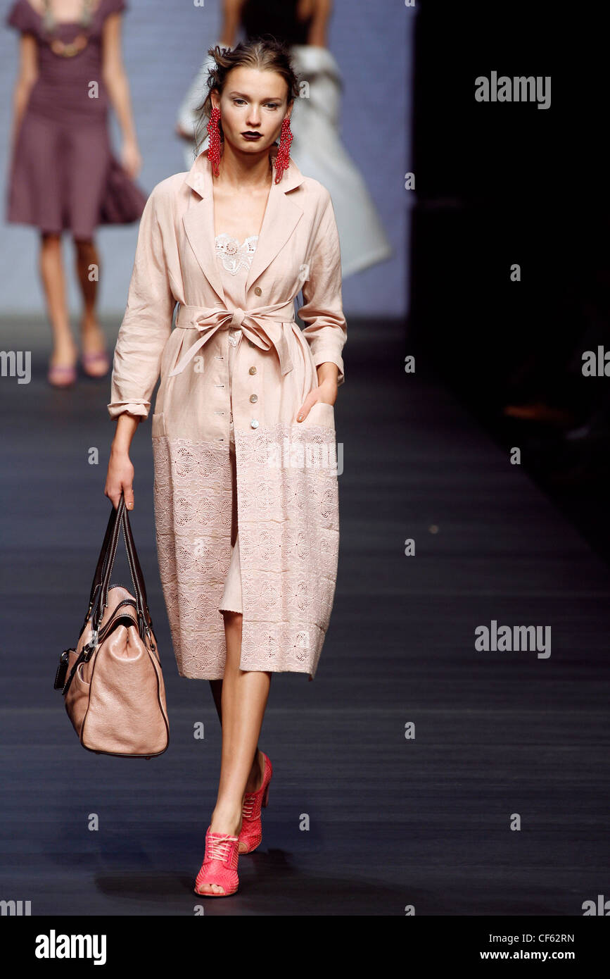 Mariella Burani Milan Ready to Wear Spring Summer Model wearing a pale  peach single breased belted coat lace detail, pale peach Stock Photo - Alamy