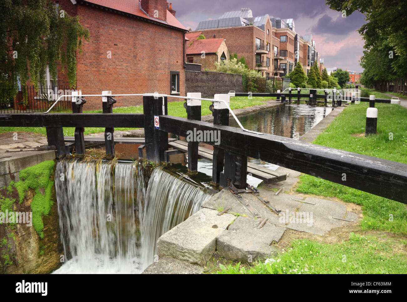 artificial waterfall and river. small houses made of red brick Stock Photo