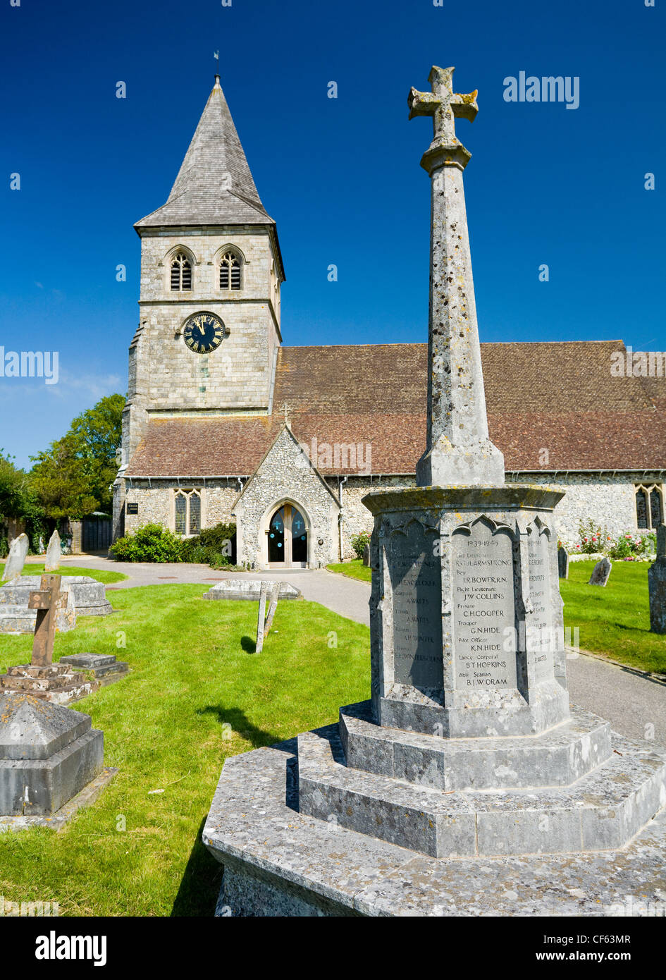 The war memorial in the church grounds of St Mary's church. Stock Photo