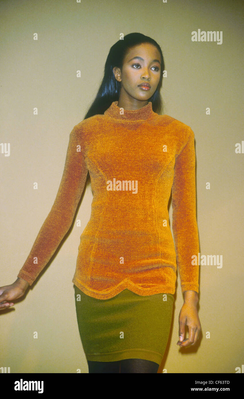 s Fashion Rifat Ozbek Model, Naomi Campbell long black hair wearing orange chenille fitted jumper green wool miniskirt and Stock Photo