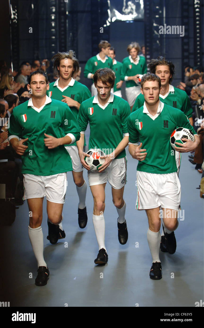 Moschino Menswear Milan A W Italian football team motif: group of males wearing Italian football team uniforms, jogging down Stock Photo