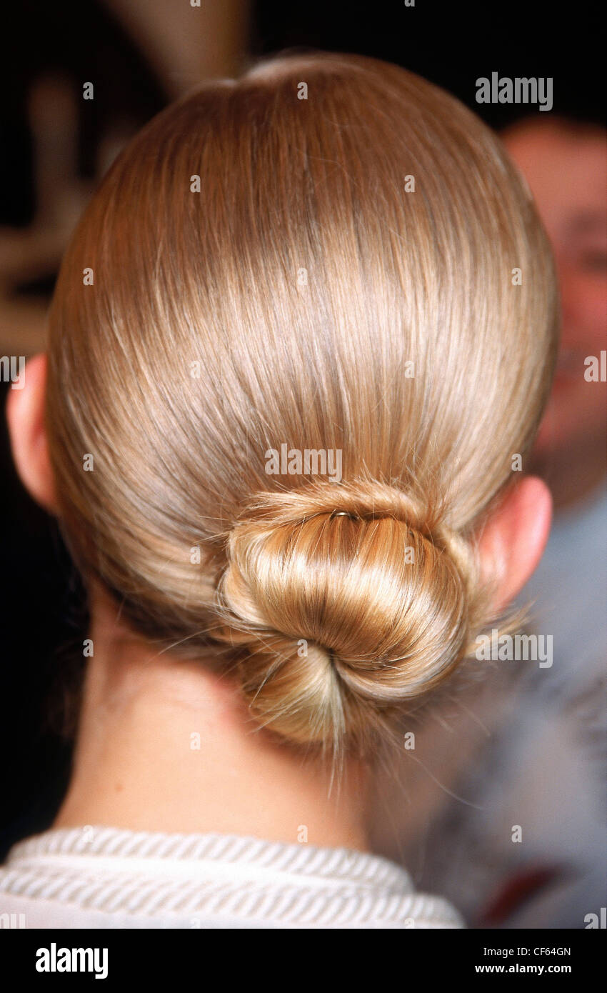 Rearview Of A Blonde Female Model S Hair Pulled Into A Low Chignon