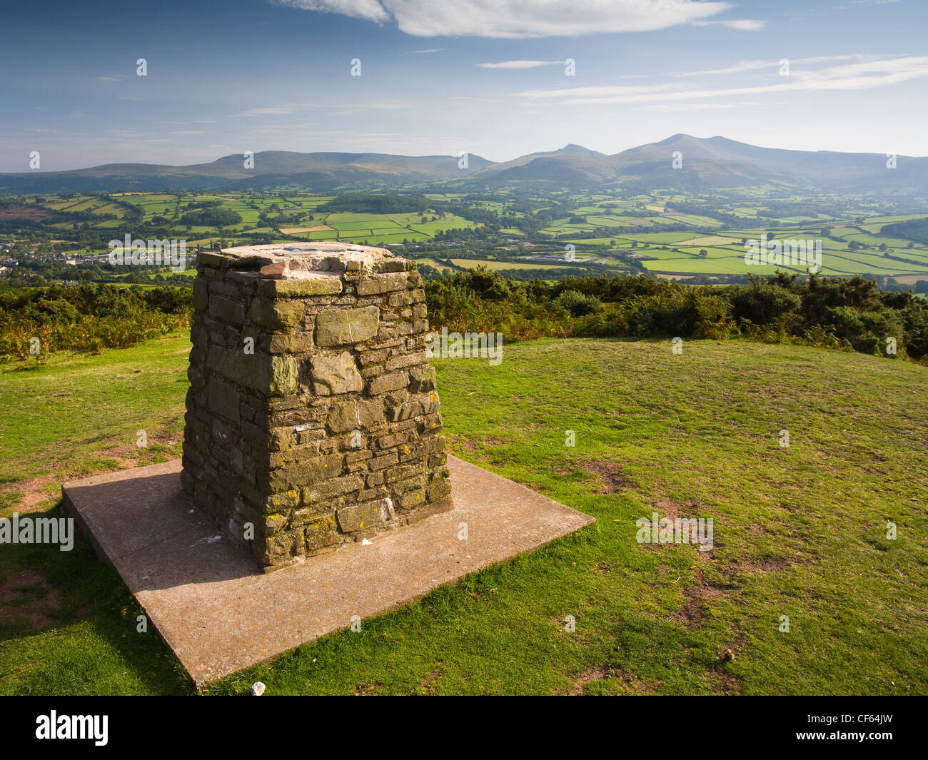 Trig point on top of Pen-y-Crug hillfort overlooking Brecon and the Usk valley in the Brecon Beacons National Park. Stock Photo