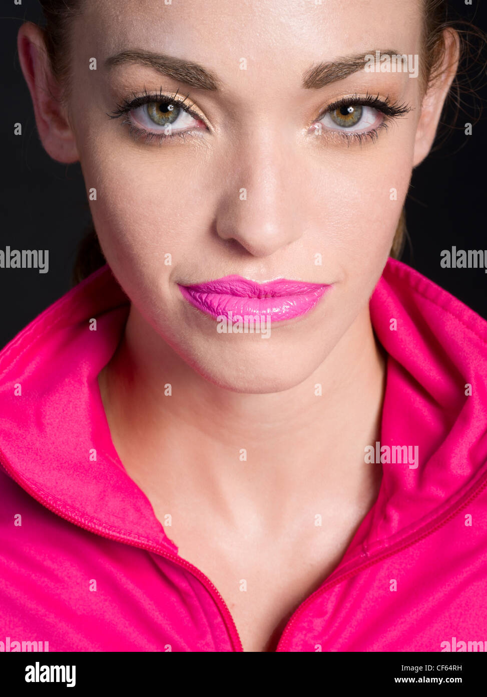 Beautiful woman wearing matching pink lipstick and jacket Stock Photo