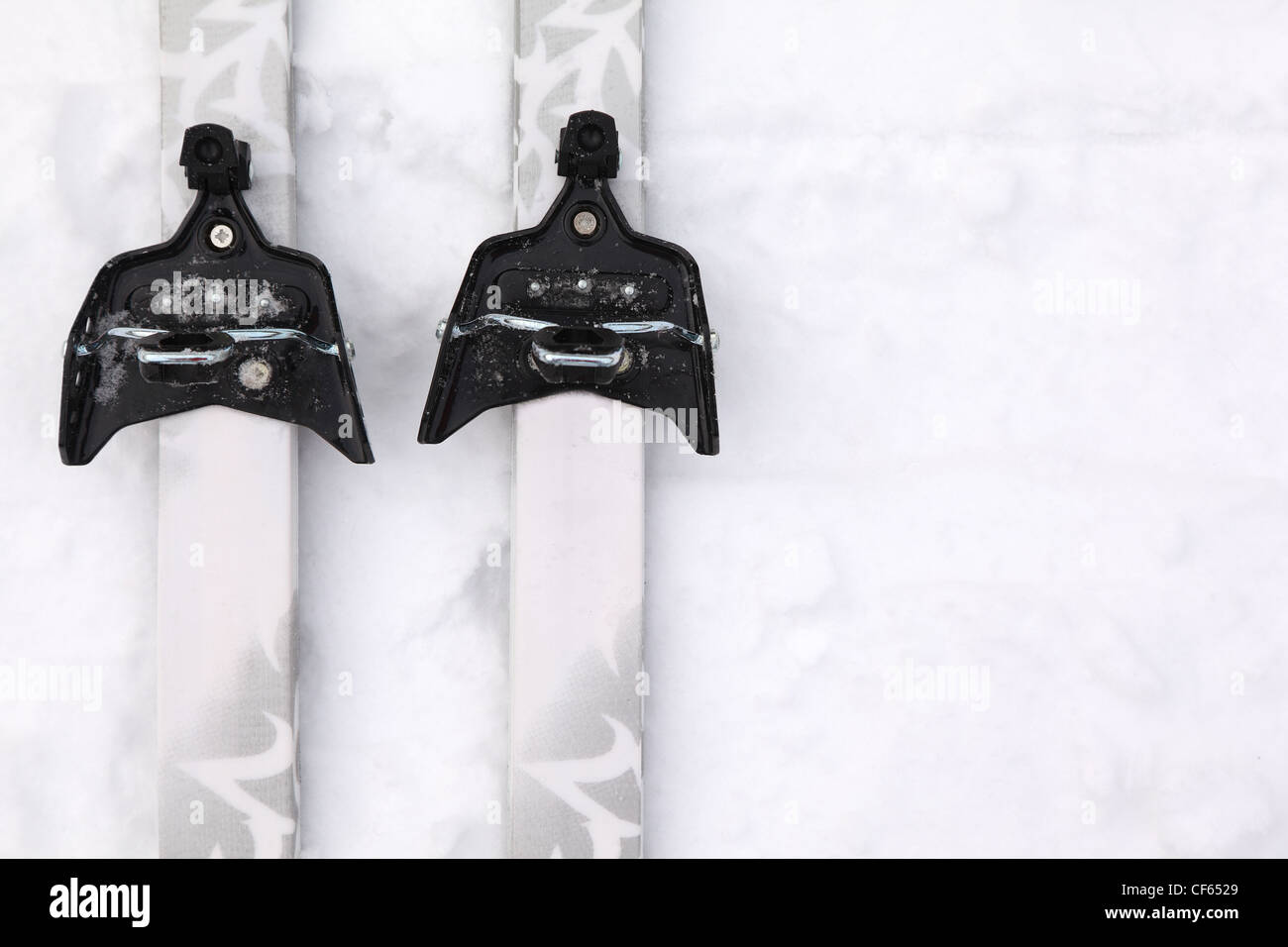 Pair of crosscountry skis with simple binding on pure white snow Stock