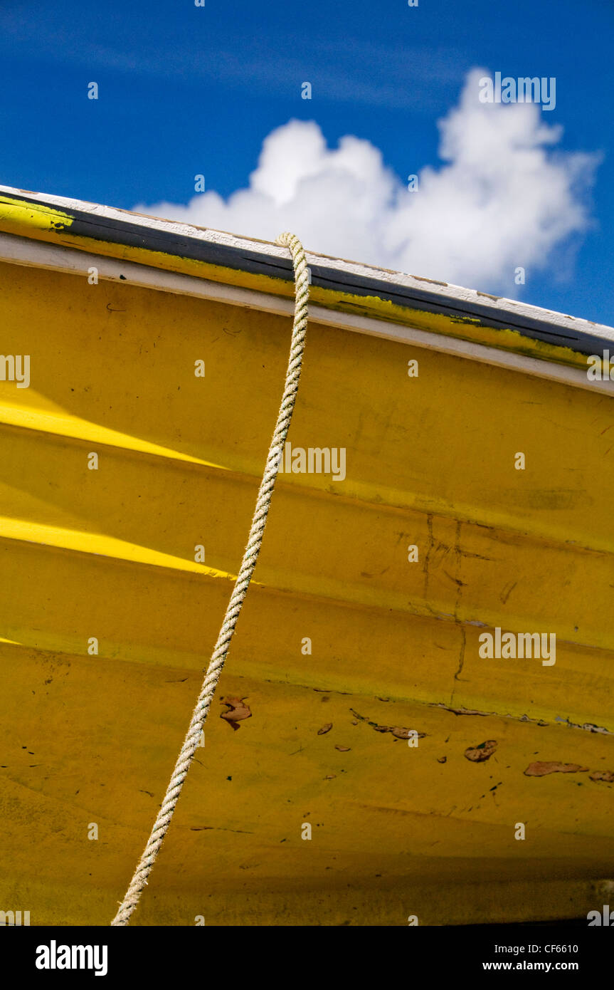 A yellow boat moored on the beach at Port Isaac. Stock Photo