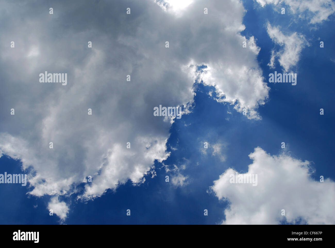 A view up at white clouds in a blue sky. Stock Photo